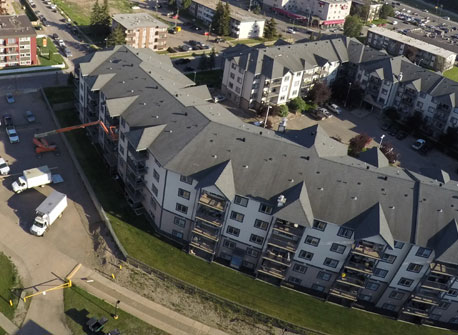 pressure washing the exterior of a large commercial building