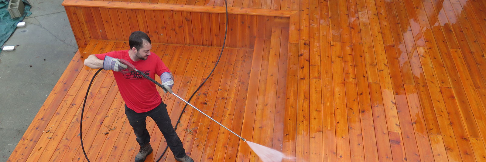 BOSSWASH employee power washing deck